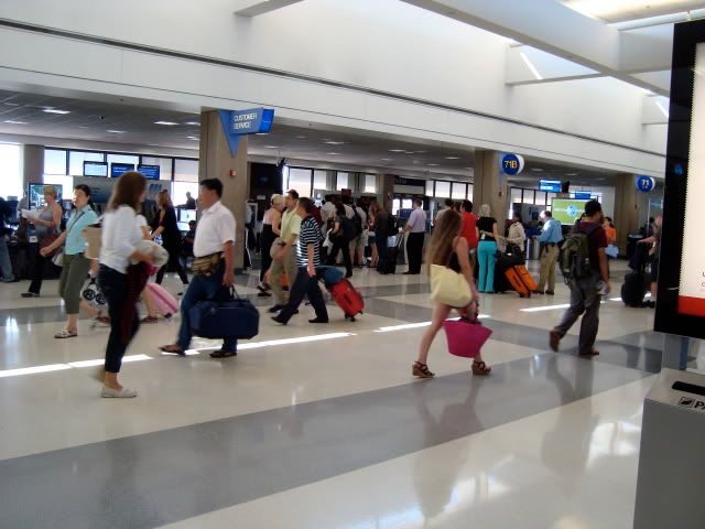 a group of people walking in an airport