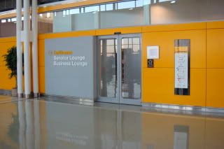 a yellow and grey wall with glass doors